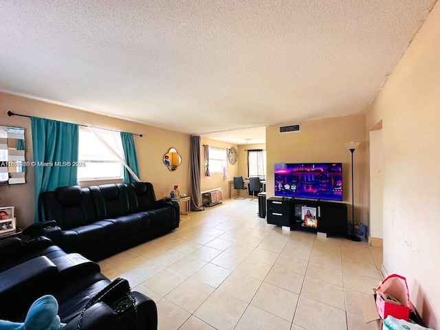 2420 Johnson St Unit 202, Hollywood, FL 33020 - living area with light tile patterned floors, a textured ceiling, and plenty of natural light