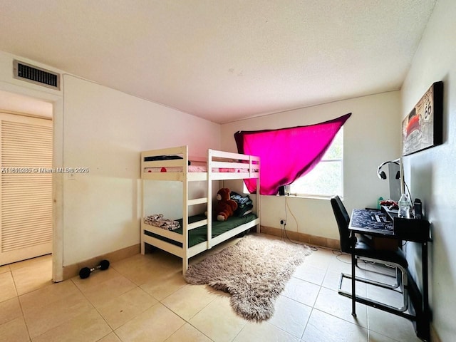 2420 Johnson St Unit 202, Hollywood, FL 33020 - bedroom with baseboards, tile patterned flooring, and a textured ceiling