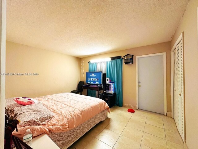 2420 Johnson St Unit 202, Hollywood, FL 33020 - tiled bedroom with a textured ceiling