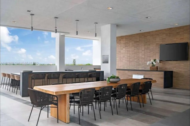 3900 Biscayne Blvd Unit N-1011, Miami, FL 33137 - dining space featuring tile patterned floors and brick wall