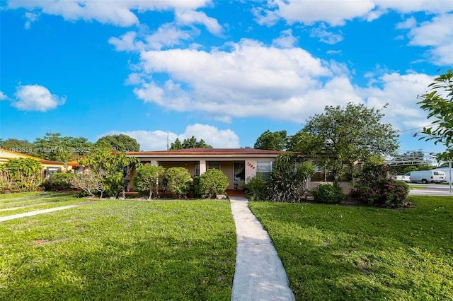 7280 SW 9th St, Miami, FL 33144 - view of front of property with a front lawn and stucco siding