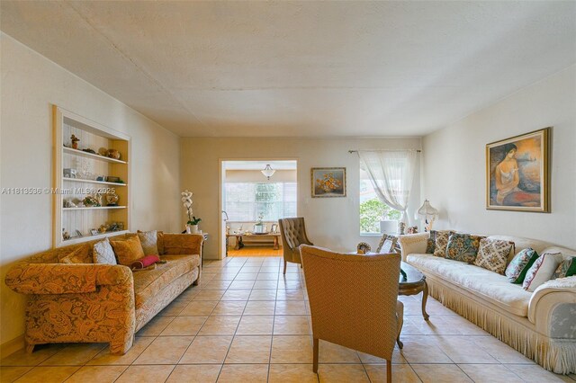 7280 SW 9th St, Miami, FL 33144 - living room featuring light tile patterned flooring and built in shelves