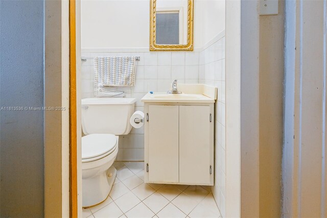 7280 SW 9th St, Miami, FL 33144 - bathroom featuring toilet, tile patterned flooring, vanity, and tile walls