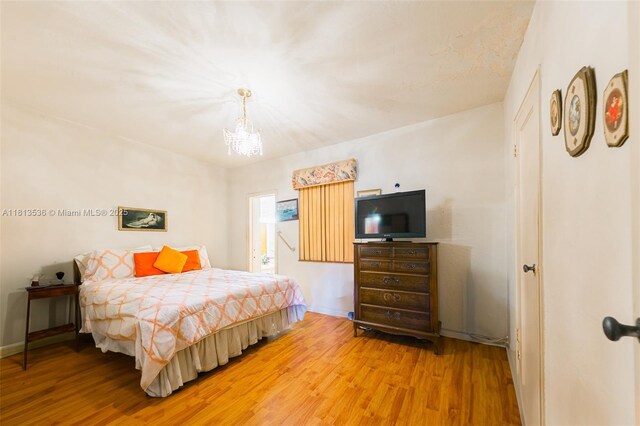 7280 SW 9th St, Miami, FL 33144 - bedroom featuring light wood finished floors, a chandelier, and baseboards