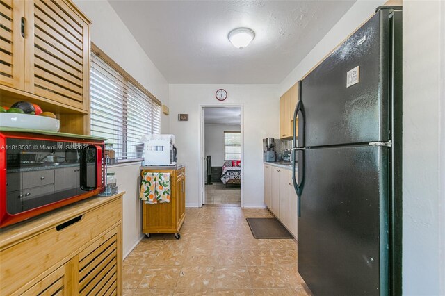 7280 SW 9th St, Miami, FL 33144 - kitchen featuring black appliances, light floors, and light countertops