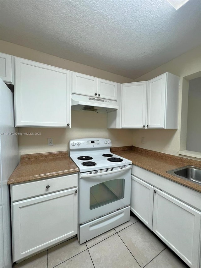 8740 N Sherman Cir Unit 308, Miramar, FL 33025 - kitchen with white electric range, under cabinet range hood, white cabinetry, light tile patterned flooring, and a textured ceiling