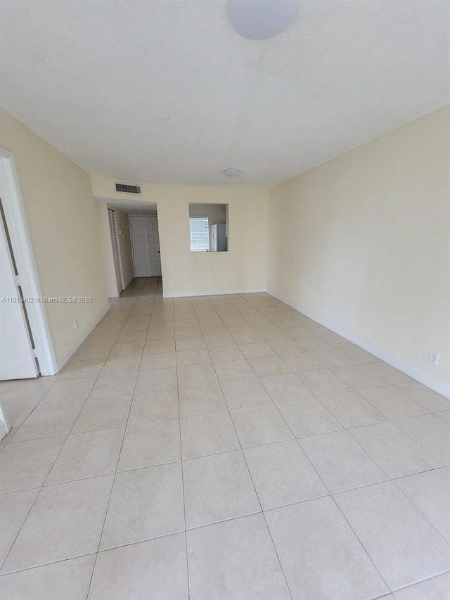 8740 N Sherman Cir Unit 308, Miramar, FL 33025 - spare room with light tile patterned floors and baseboards