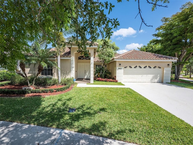 643 Lake Blvd, Weston, FL 33326 - view of front of property with stucco siding, a garage, a front lawn, and driveway