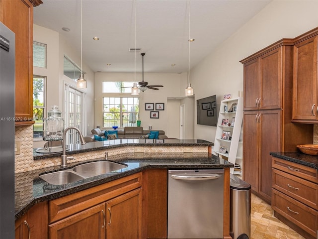 643 Lake Blvd, Weston, FL 33326 - kitchen with dishwasher, a sink, open floor plan, brown cabinets, and dark stone counters