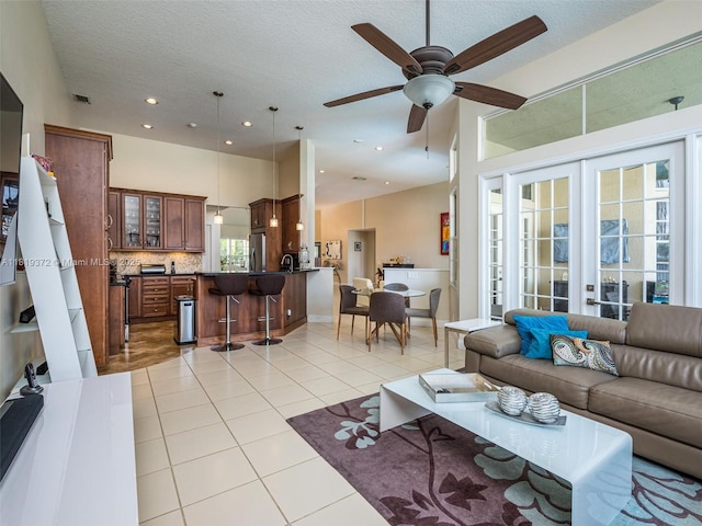 643 Lake Blvd, Weston, FL 33326 - living room featuring light tile patterned flooring, ceiling fan, french doors, recessed lighting, and a textured ceiling