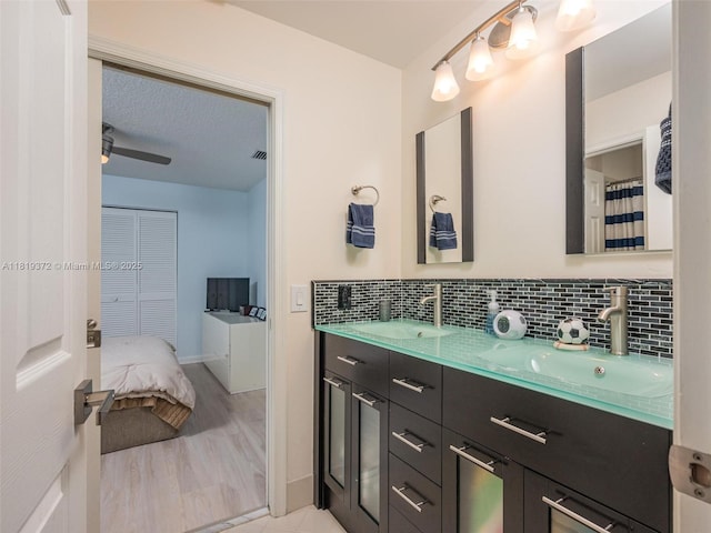 643 Lake Blvd, Weston, FL 33326 - bathroom with double vanity and tasteful backsplash