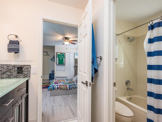 643 Lake Blvd, Weston, FL 33326 - ensuite bathroom featuring vanity, shower / tub combo, a ceiling fan, wood finished floors, and toilet
