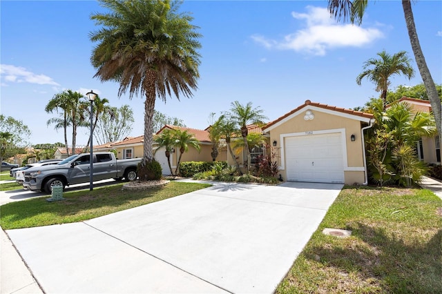 7182 Burgess Dr, Lake Worth, FL 33467 - mediterranean / spanish-style home with stucco siding, driveway, a tiled roof, and a garage