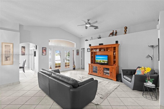 7182 Burgess Dr, Lake Worth, FL 33467 - living area featuring a ceiling fan, arched walkways, light tile patterned floors, french doors, and high vaulted ceiling