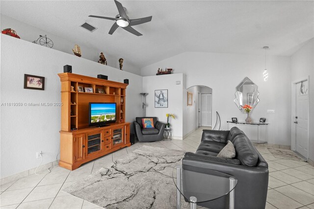 7182 Burgess Dr, Lake Worth, FL 33467 - tiled living room featuring arched walkways, ceiling fan, lofted ceiling, and baseboards