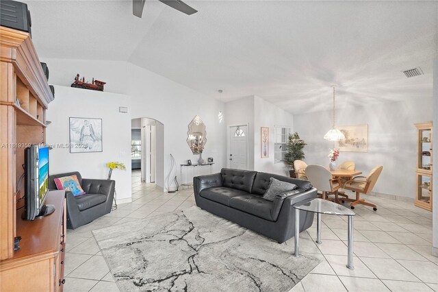 7182 Burgess Dr, Lake Worth, FL 33467 - living area featuring arched walkways, lofted ceiling, ceiling fan, and light tile patterned floors