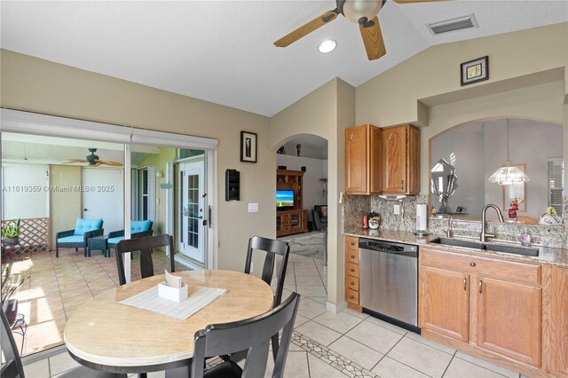 7182 Burgess Dr, Lake Worth, FL 33467 - kitchen with ceiling fan, stainless steel dishwasher, a sink, lofted ceiling, and arched walkways