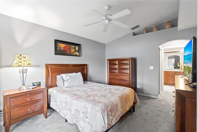 7182 Burgess Dr, Lake Worth, FL 33467 - bedroom featuring light carpet, vaulted ceiling, arched walkways, and ceiling fan