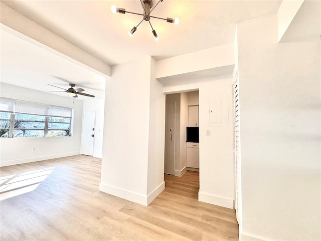 4740 Pine Tree Dr Unit 28, Miami Beach, FL 33140 - spare room featuring light wood finished floors, a chandelier, and baseboards