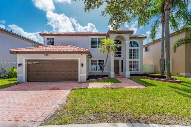 2635 SW 183rd Ave, Miramar, FL 33029 - mediterranean / spanish-style house featuring stucco siding, an attached garage, driveway, a front yard, and a tiled roof