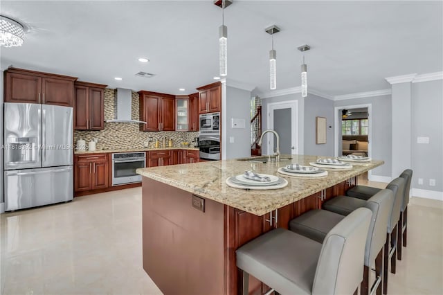 2635 SW 183rd Ave, Miramar, FL 33029 - kitchen with stainless steel appliances, wall chimney exhaust hood, crown molding, decorative backsplash, and hanging light fixtures