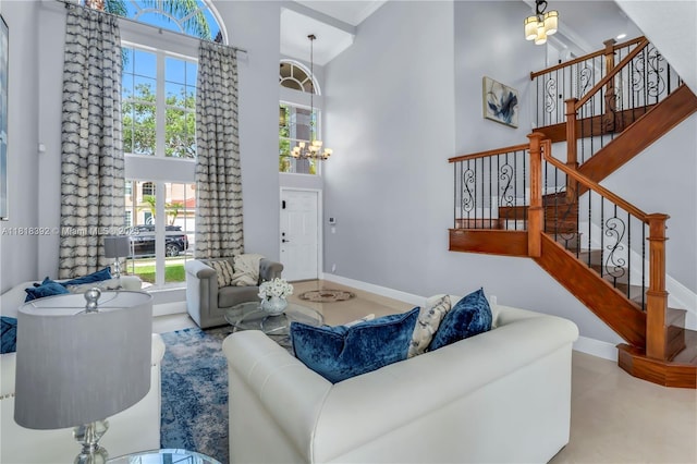 2635 SW 183rd Ave, Miramar, FL 33029 - living room with a high ceiling, plenty of natural light, stairs, a chandelier, and ornamental molding