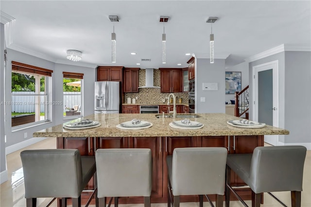 2635 SW 183rd Ave, Miramar, FL 33029 - kitchen with appliances with stainless steel finishes, wall chimney range hood, crown molding, backsplash, and pendant lighting
