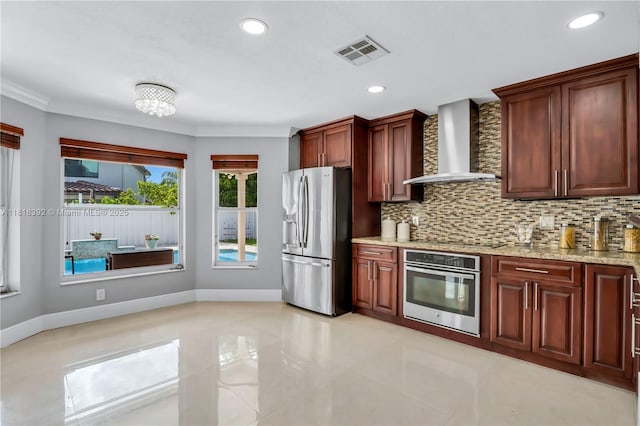 2635 SW 183rd Ave, Miramar, FL 33029 - kitchen featuring appliances with stainless steel finishes, wall chimney exhaust hood, tasteful backsplash, light stone counters, and recessed lighting