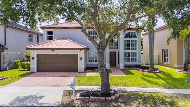 2635 SW 183rd Ave, Miramar, FL 33029 - mediterranean / spanish home featuring stucco siding, a tile roof, an attached garage, decorative driveway, and a front yard