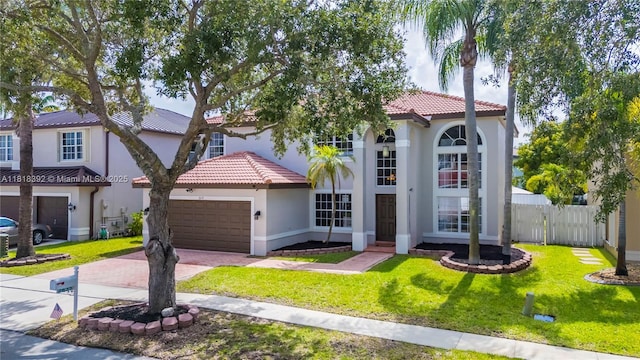 2635 SW 183rd Ave, Miramar, FL 33029 - mediterranean / spanish house featuring a tiled roof, stucco siding, an attached garage, and decorative driveway