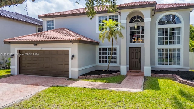 2635 SW 183rd Ave, Miramar, FL 33029 - mediterranean / spanish home featuring stucco siding, a garage, decorative driveway, and a tiled roof