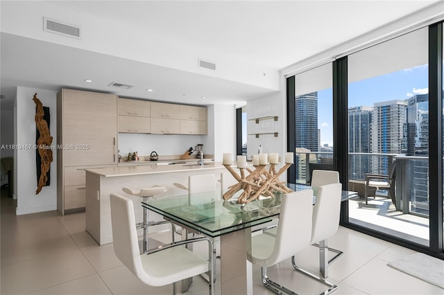 1300 S Miami Ave Unit 2305, Miami, FL 33130 - dining room featuring light tile patterned floors, a view of city, and a wall of windows