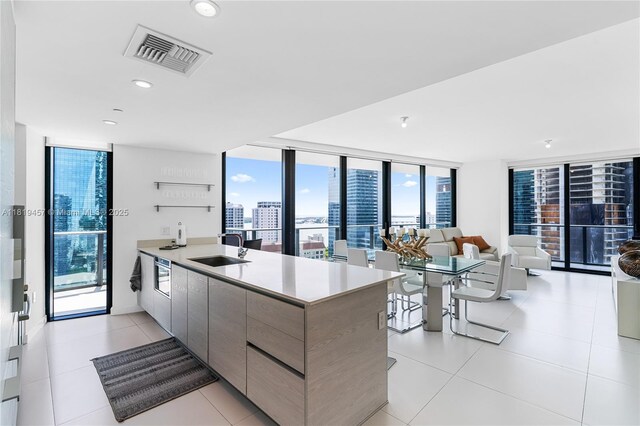 1300 S Miami Ave Unit 2305, Miami, FL 33130 - kitchen featuring a sink, modern cabinets, a peninsula, a wall of windows, and open floor plan
