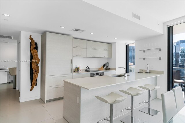 1300 S Miami Ave Unit 2305, Miami, FL 33130 - kitchen with a sink, modern cabinets, a kitchen breakfast bar, light countertops, and a peninsula