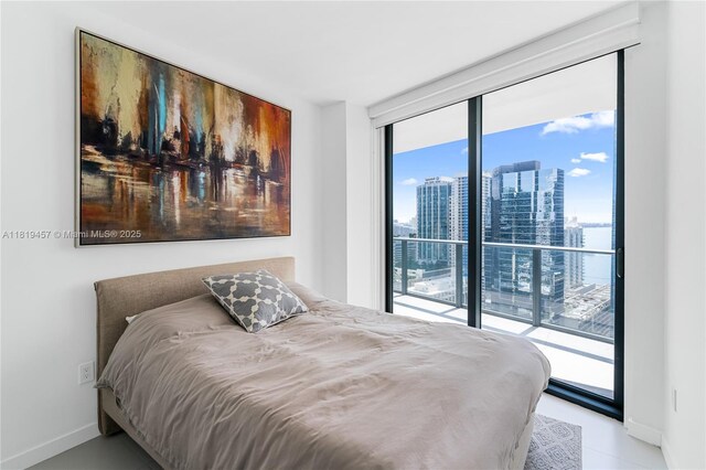 1300 S Miami Ave Unit 2305, Miami, FL 33130 - bedroom with access to outside, multiple windows, a view of skyline, baseboards, and a wall of windows