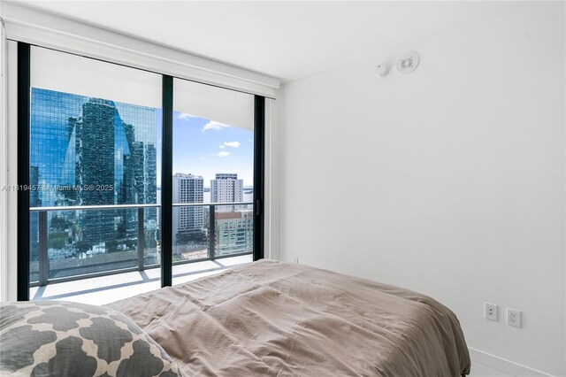 1300 S Miami Ave Unit 2305, Miami, FL 33130 - bedroom featuring a wall of windows and a view of skyline