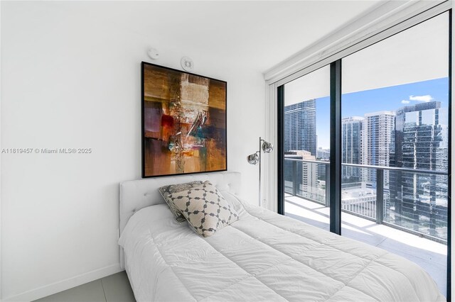 1300 S Miami Ave Unit 2305, Miami, FL 33130 - tiled bedroom with a city view, access to outside, expansive windows, and baseboards