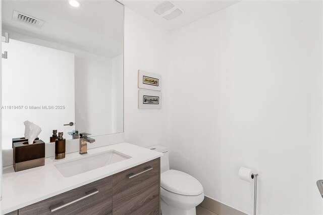 1300 S Miami Ave Unit 2305, Miami, FL 33130 - half bathroom with toilet, vanity, baseboards, and recessed lighting
