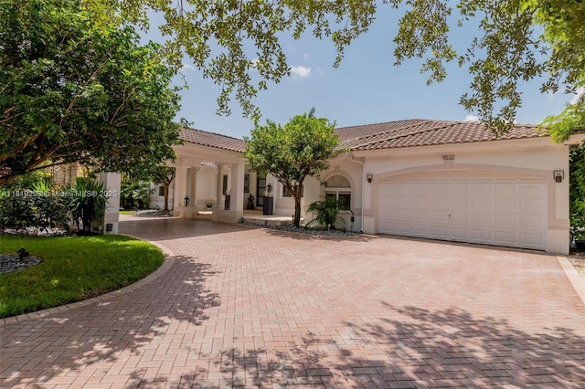 9532 SW 124th Ter, Miami, FL 33176 - mediterranean / spanish-style home with stucco siding, decorative driveway, a garage, and a tiled roof