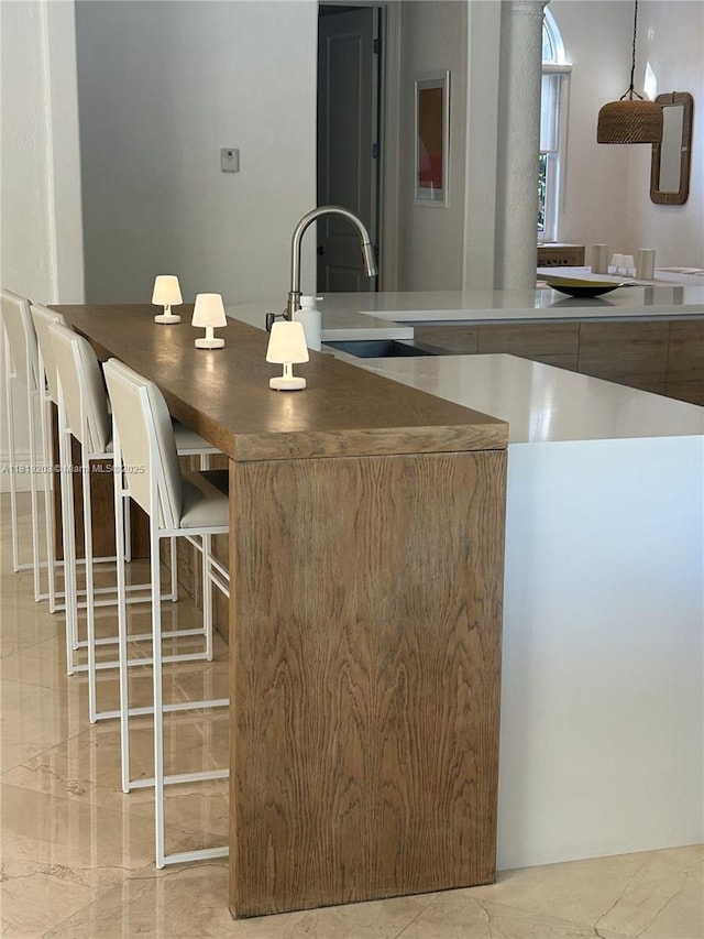 9532 SW 124th Ter, Miami, FL 33176 - kitchen with light marble finish floors and a kitchen breakfast bar