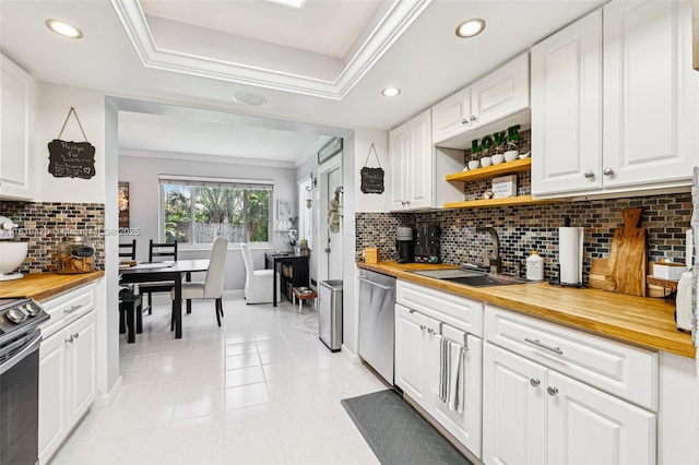 2375 NW 81st Ave, Sunrise, FL 33322 - kitchen featuring butcher block countertops, appliances with stainless steel finishes, recessed lighting, ornamental molding, and backsplash