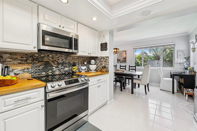 2375 NW 81st Ave, Sunrise, FL 33322 - kitchen featuring stainless steel appliances, ornamental molding, backsplash, white cabinetry, and wood counters