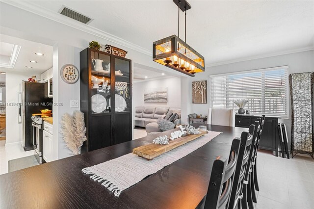 2375 NW 81st Ave, Sunrise, FL 33322 - dining space with ornamental molding and light tile patterned floors