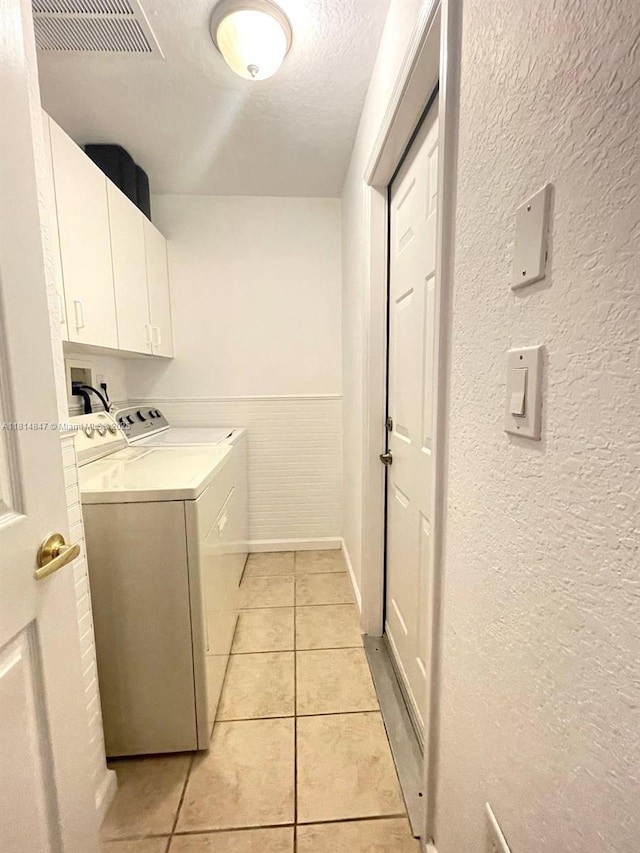18796 SW 27th Ct, Miramar, FL 33029 - washroom with washing machine and dryer, cabinet space, light tile patterned floors, a textured wall, and a wainscoted wall