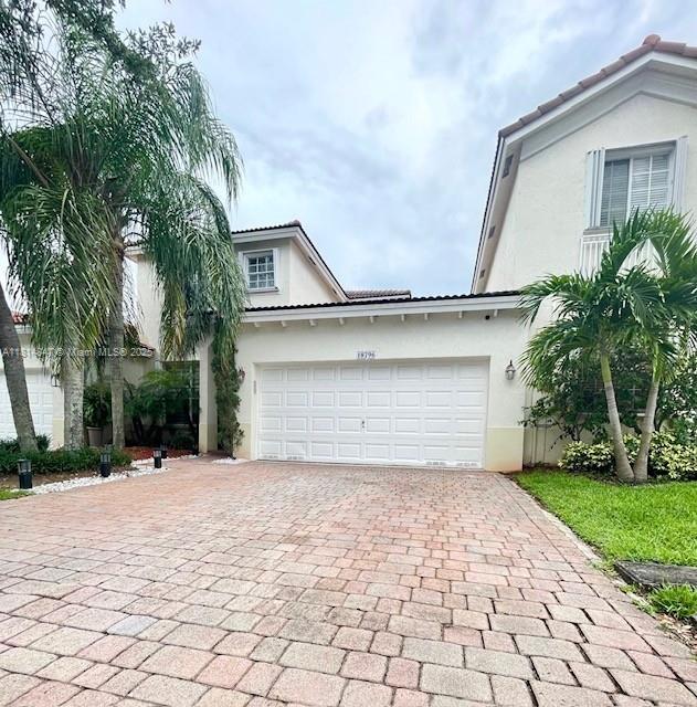 18796 SW 27th Ct, Miramar, FL 33029 - view of front facade featuring stucco siding, decorative driveway, a tile roof, and a garage