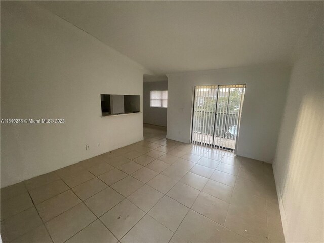 4011 NW 87th Ave Unit 4011, Sunrise, FL 33351 - unfurnished room featuring light tile patterned floors and lofted ceiling