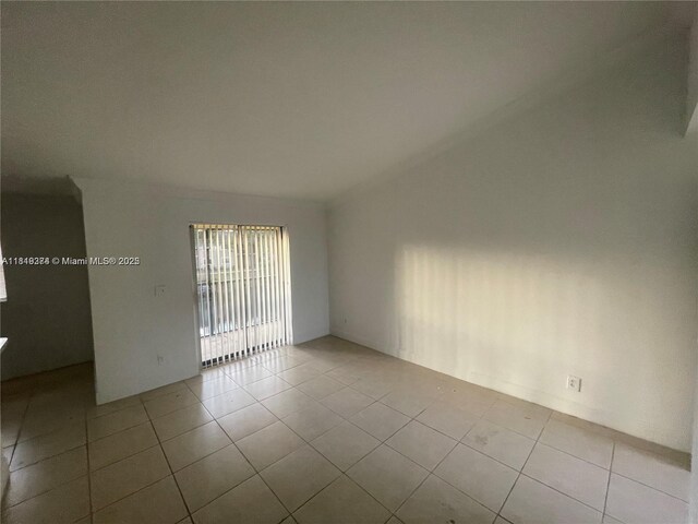 4011 NW 87th Ave Unit 4011, Sunrise, FL 33351 - tiled spare room featuring vaulted ceiling