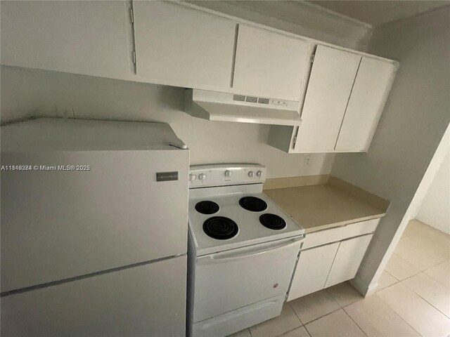 4011 NW 87th Ave Unit 4011, Sunrise, FL 33351 - kitchen featuring white appliances, under cabinet range hood, light tile patterned floors, light countertops, and white cabinetry