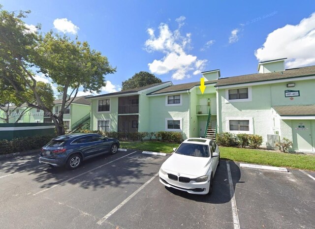 4011 NW 87th Ave Unit 4011, Sunrise, FL 33351 - view of property featuring uncovered parking and stairs