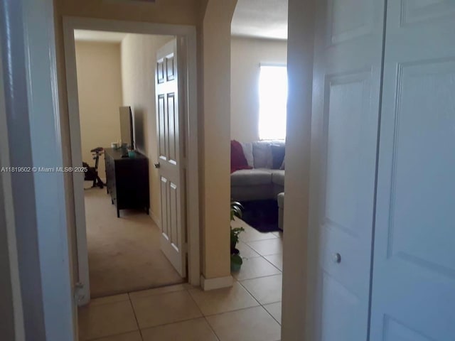 134 SE 28th Ter Unit 21, Homestead, FL 33033 - corridor featuring arched walkways, light tile patterned floors, and light carpet
